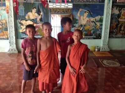 local Buddhist children offered me shelter from the monsoon in their modern stupa...